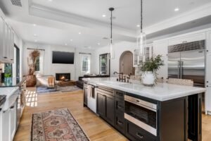 a white kitchen with lots of cabinets and counter tops on it